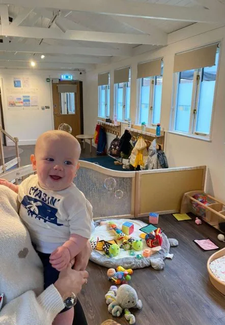 Smiling baby in the nursery playroom