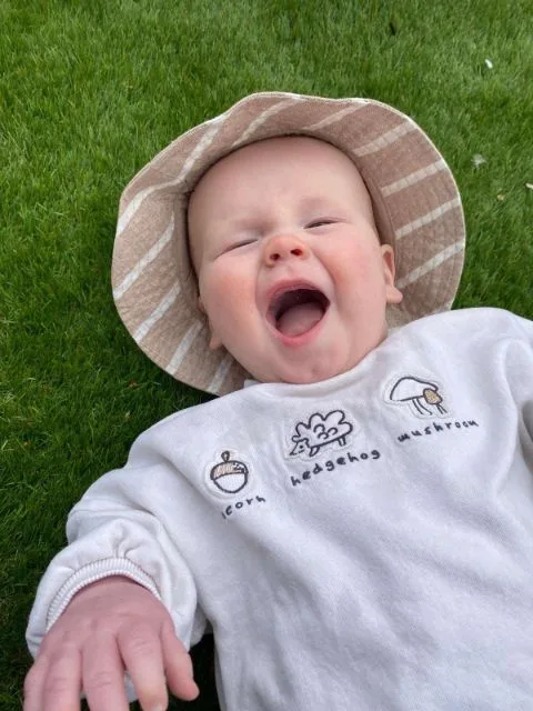 A smiling baby at Clayesmore Nursery