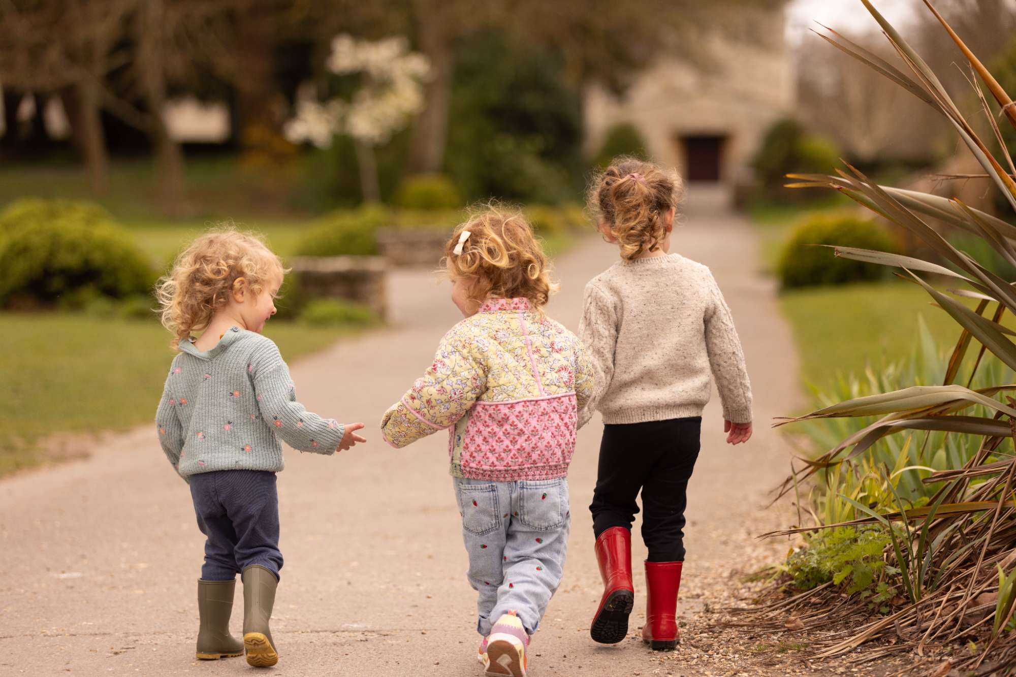 Two Pre-School children walking outdoors together at Clayesmore Nursery