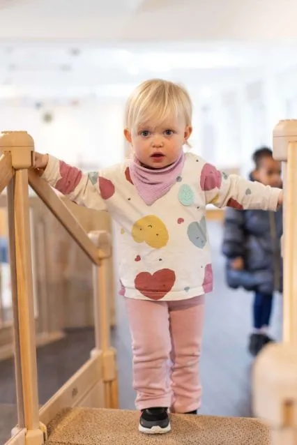 A toddler exploring the Toddler room at Clayesmore Nursery