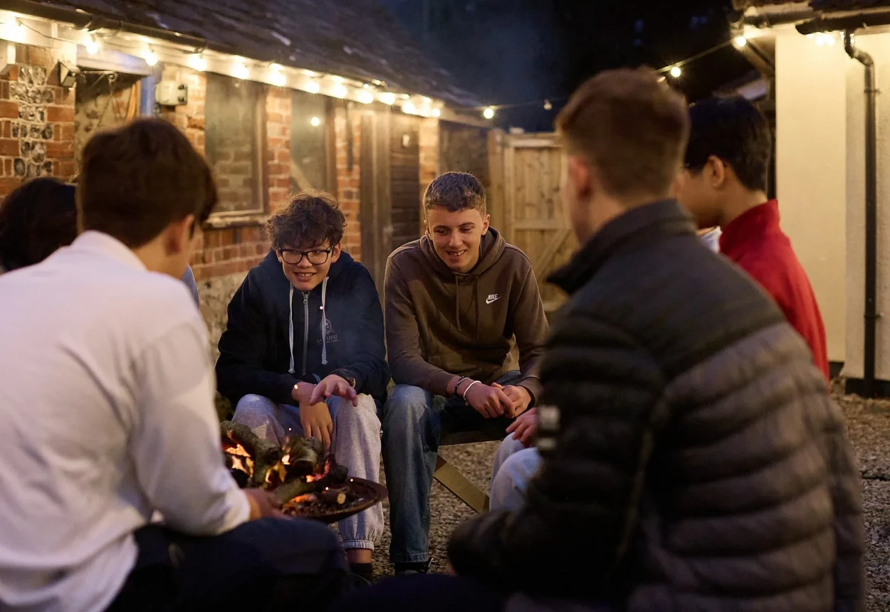 Boarders around a campfire in the evening
