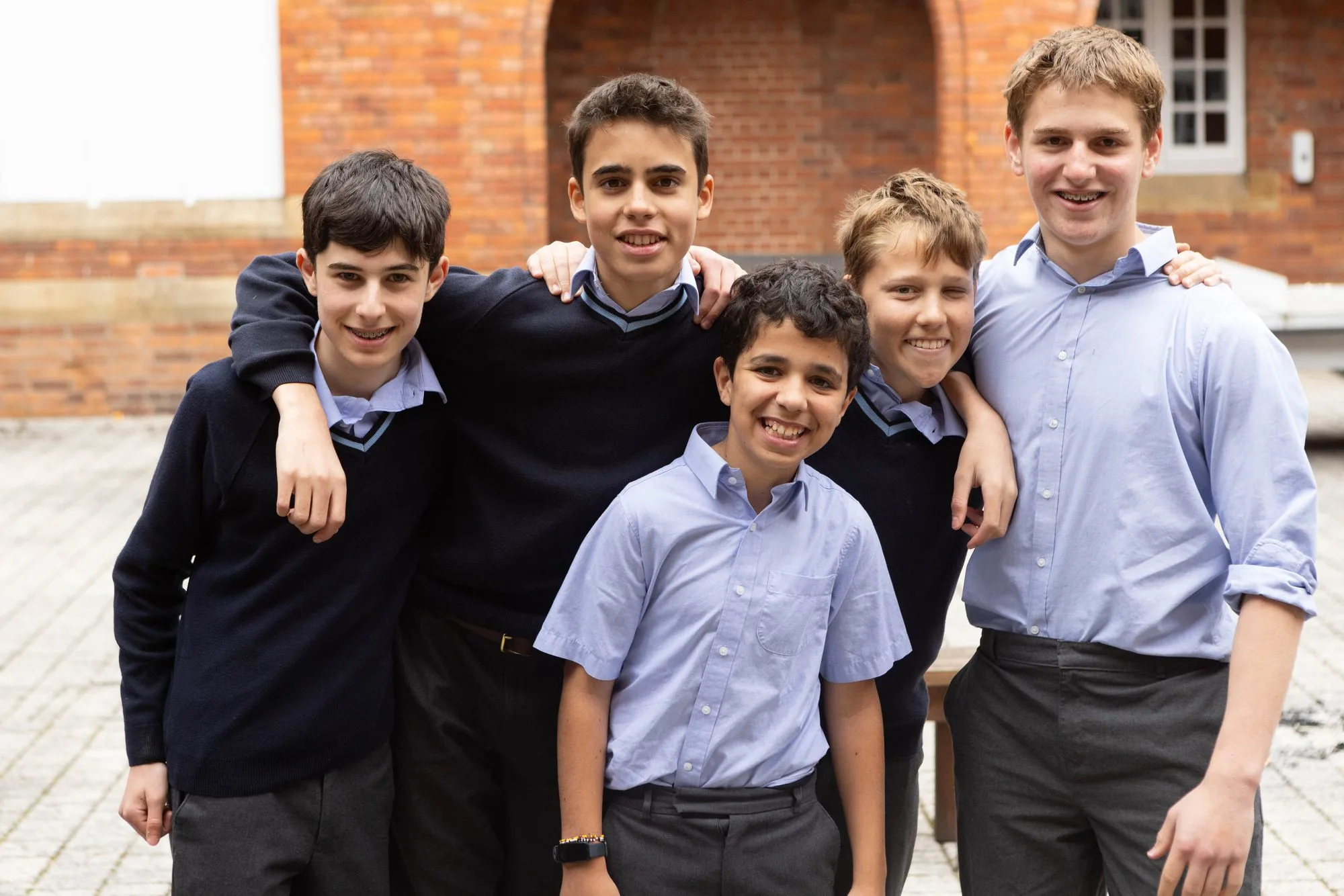 Boarders together outside their house