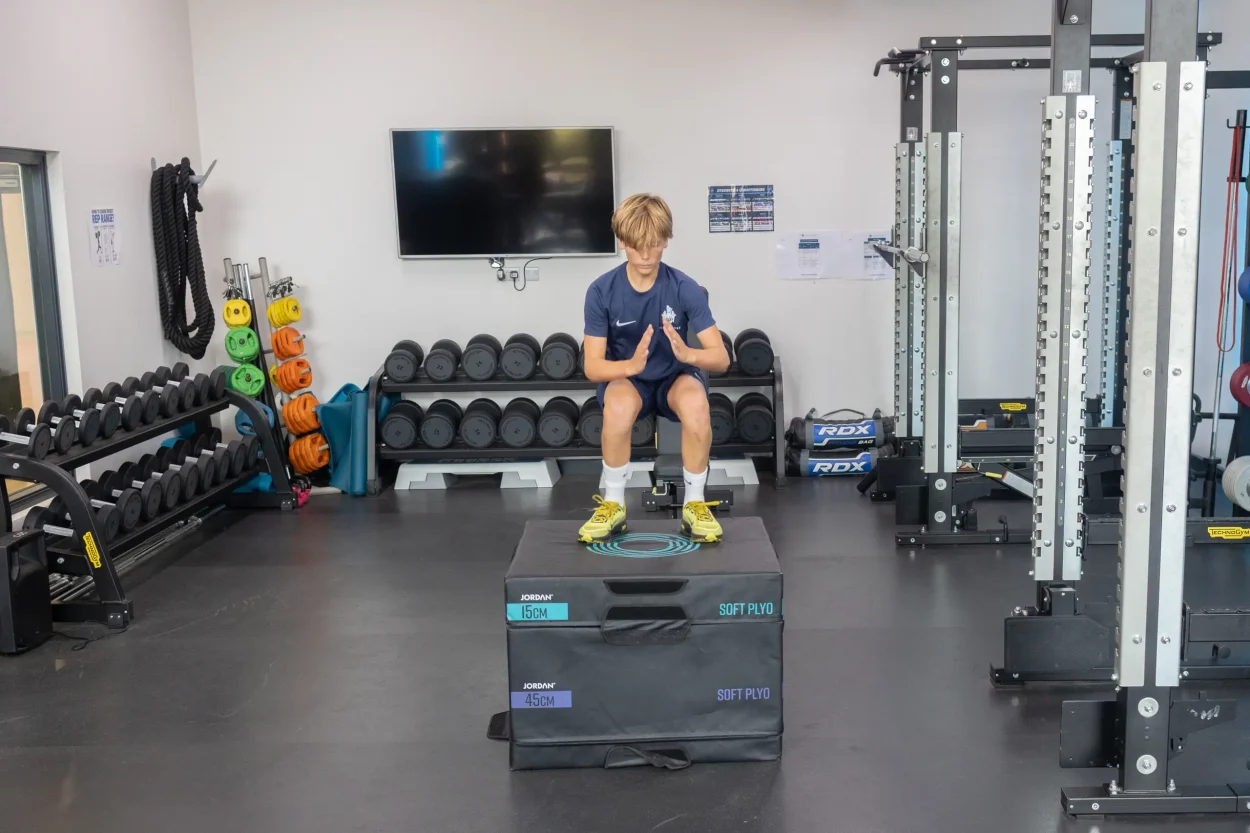 International football academy jumping on a box