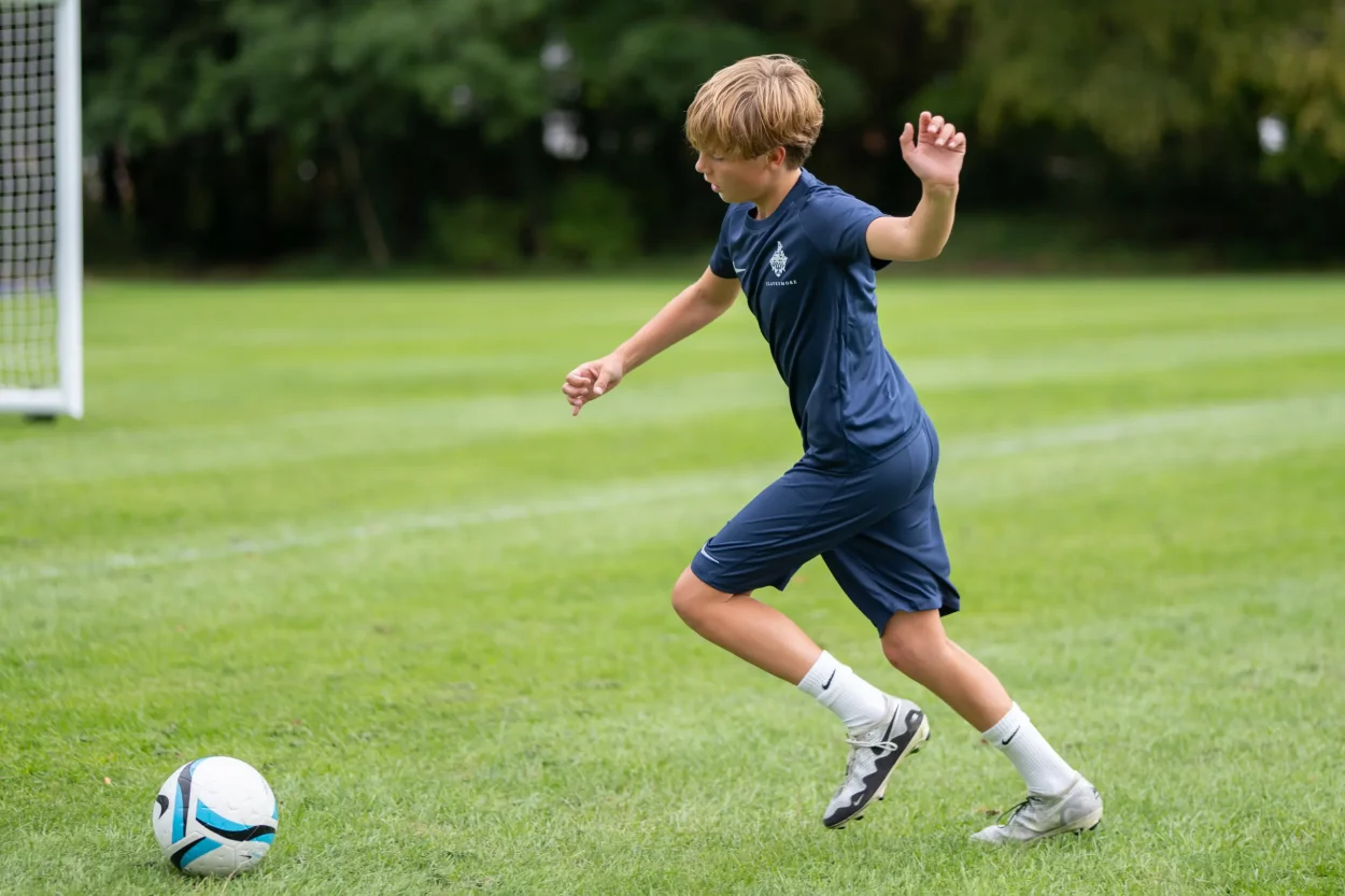 kicking a football on the field