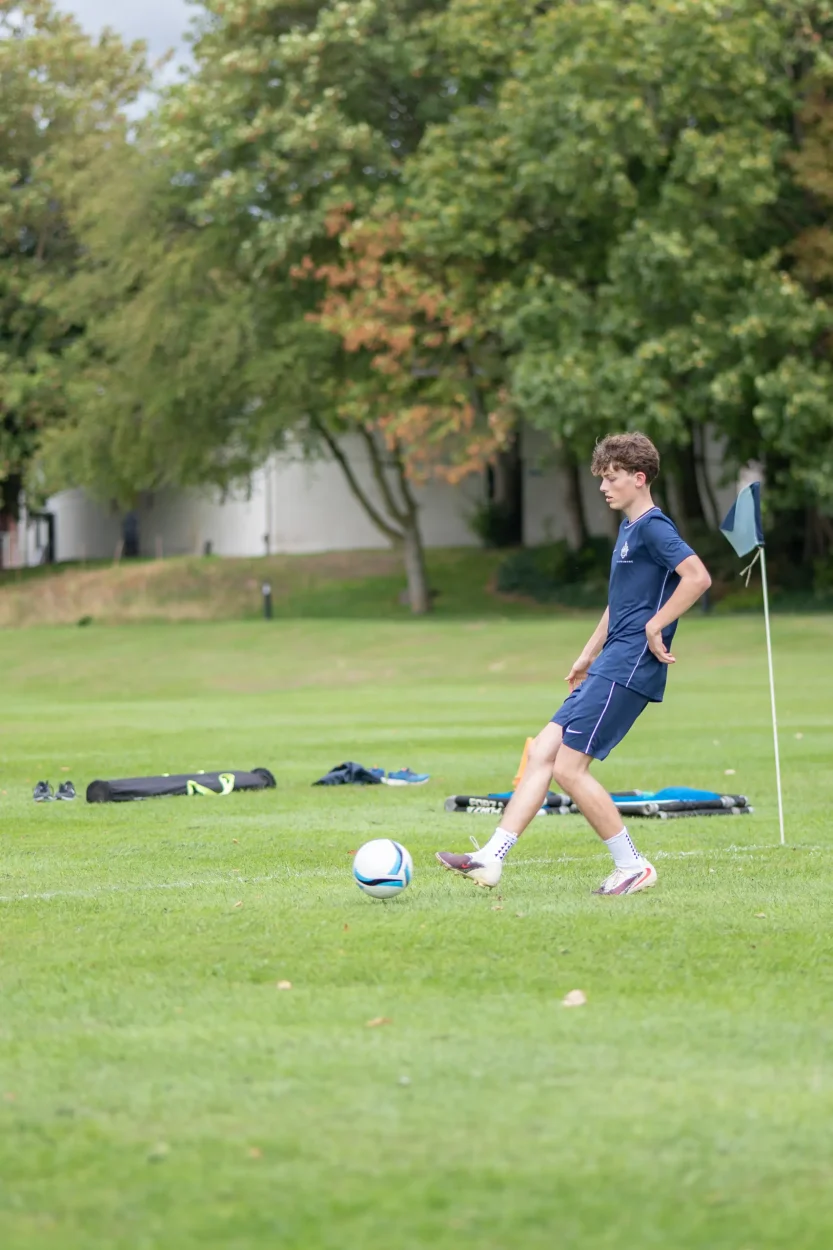 pupil kicking a football