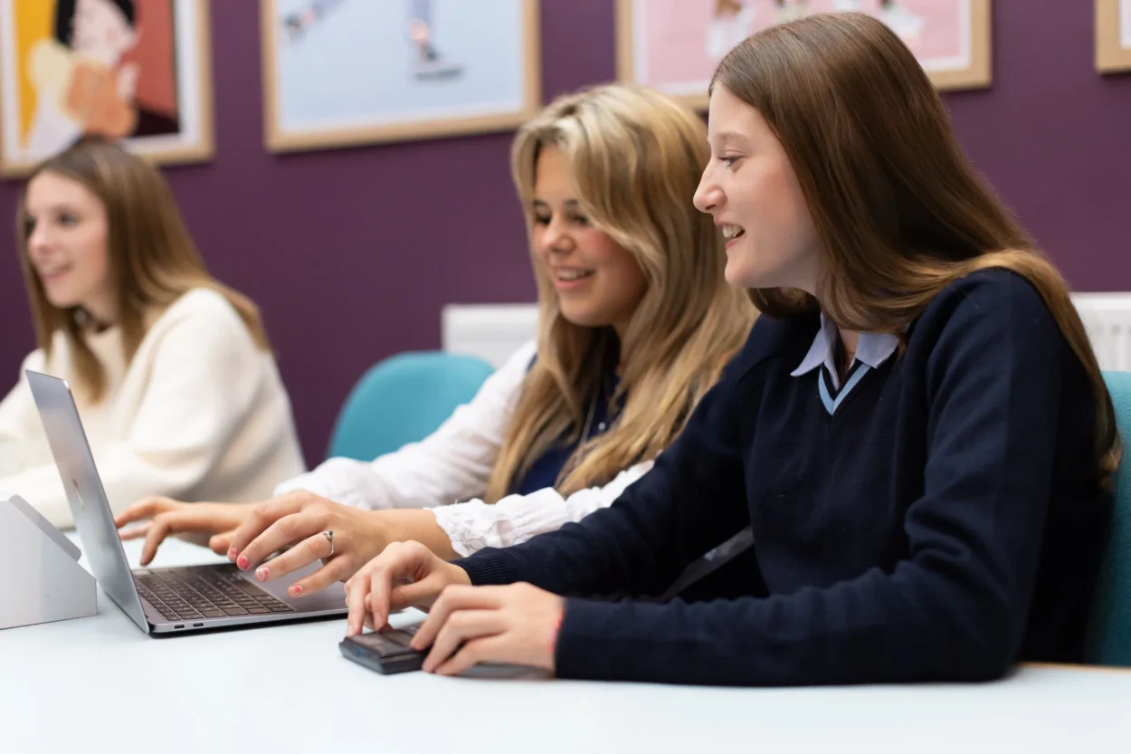 Pupils working together on laptops